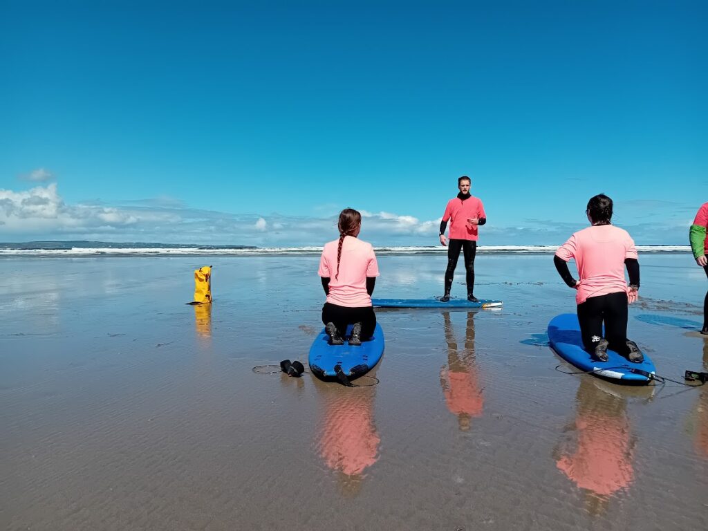 Two people getting private lesson on the beach